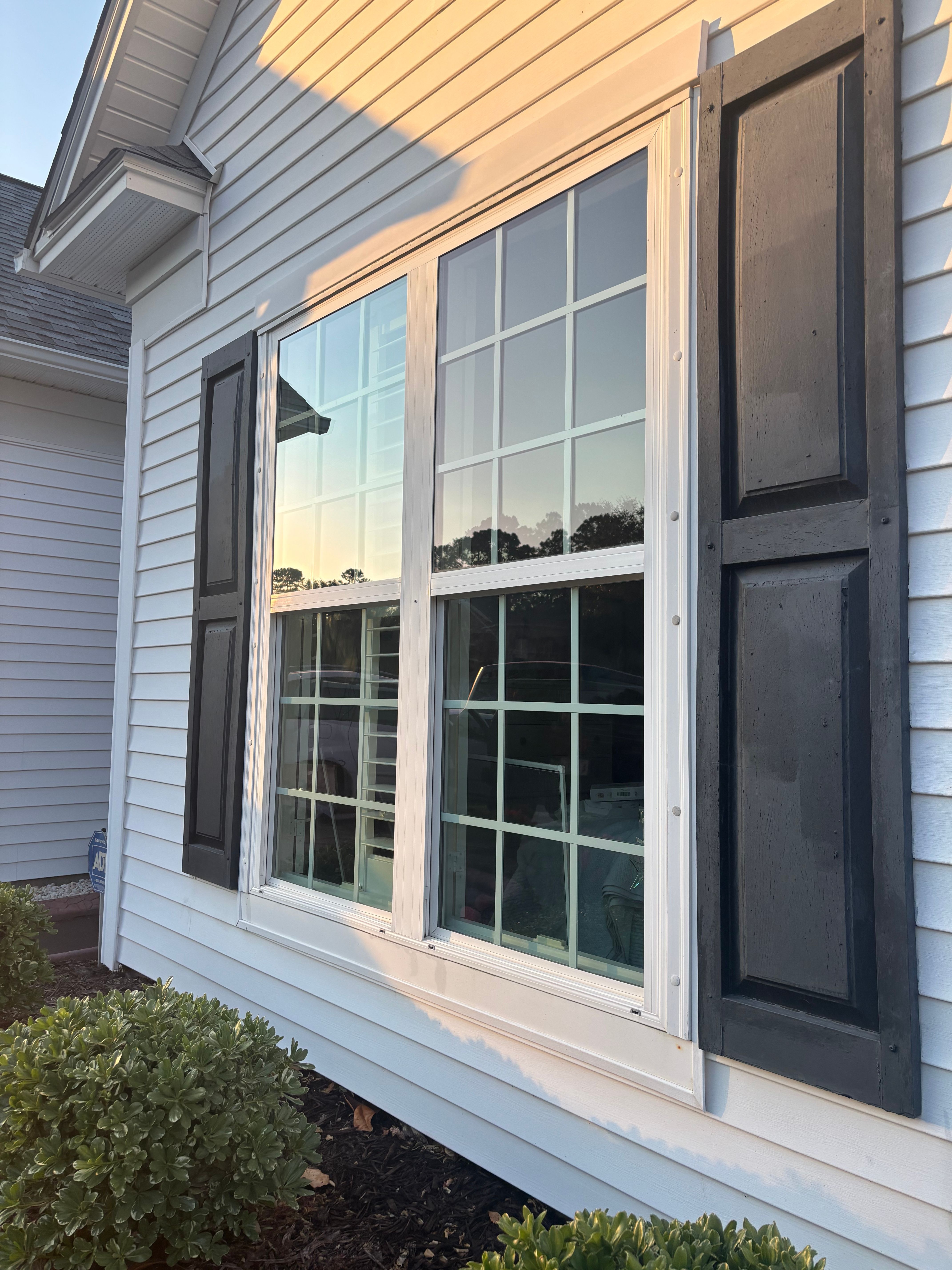 Wide front windows washed top to bottom, gaining curb appeal and natural light for this bedroom.